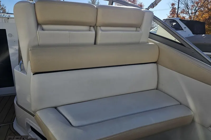 Slide: The Image of 2008 Four Winns V258 boat interior seating with beige and white upholstery. - 34