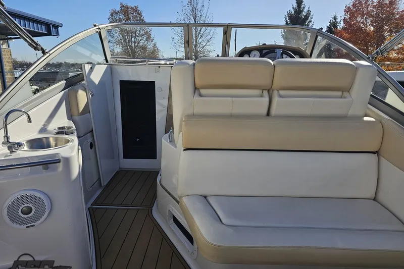 Slide: The Image of 2008 Four Winns V258 boat interior with seating, sink, and dashboard view. - 35