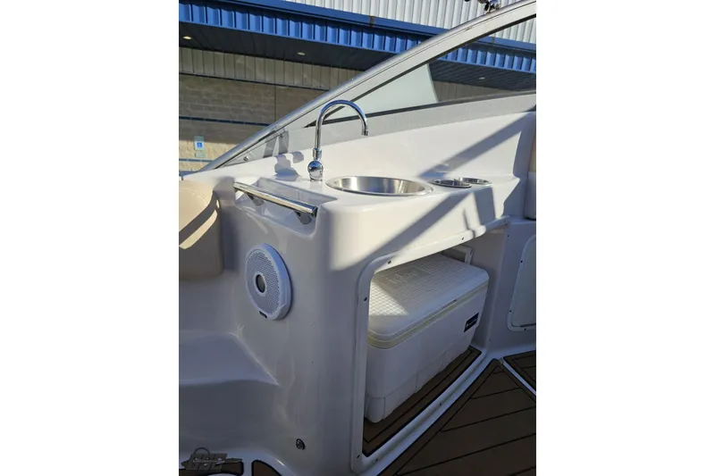 Slide: The Image of 2008 Four Winns V258 boat interior with sink, speaker, and cooler storage. - 36