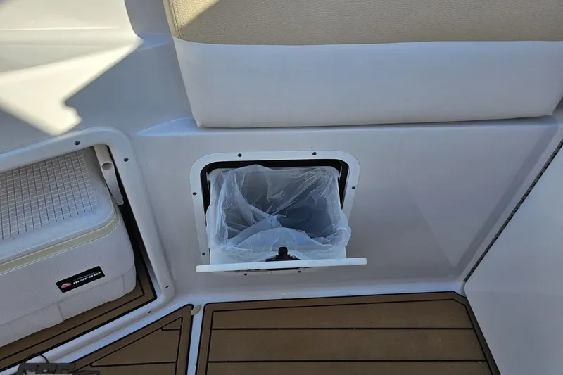 Slide: The Image of 2008 Four Winns V258 boat interior with built-in trash compartment. - 38