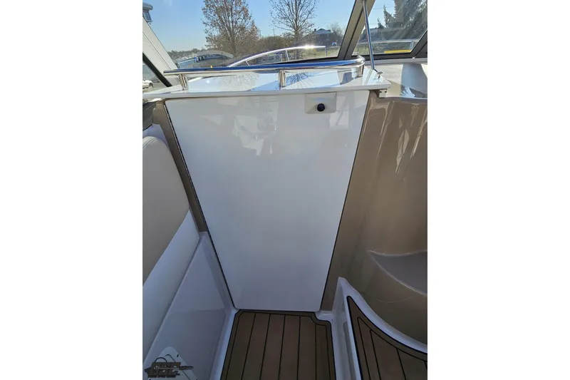 Slide: The Image of 2008 Four Winns V258 boat interior with sleek white panel and wooden flooring. - 39