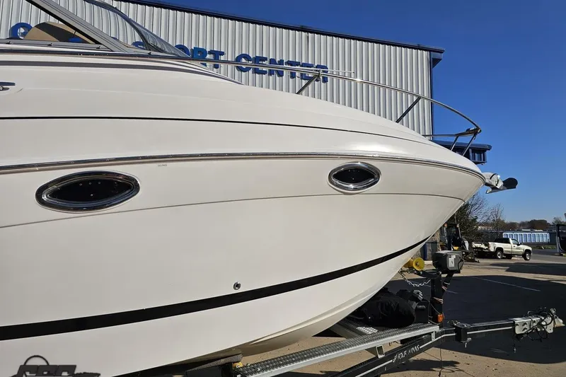 Slide: The Image of 2008 Four Winns V258 boat on trailer at a marine center. - 4