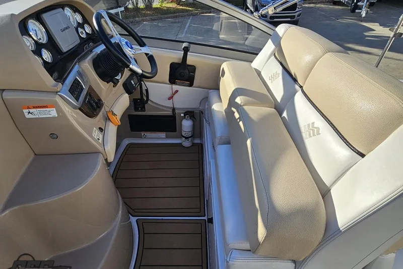 Slide: The Image of 2008 Four Winns V258 boat interior with beige seating and steering console. - 40