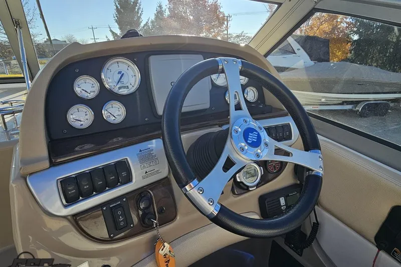 Slide: The Image of 2008 Four Winns V258 boat dashboard with steering wheel and gauges. - 42