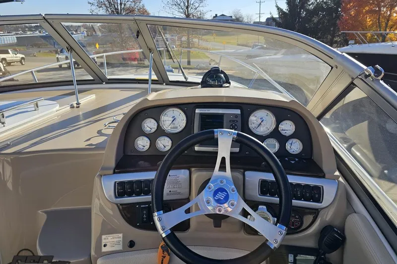 Slide: The Image of 2008 Four Winns V258 boat dashboard with steering wheel and instrument panel. - 43
