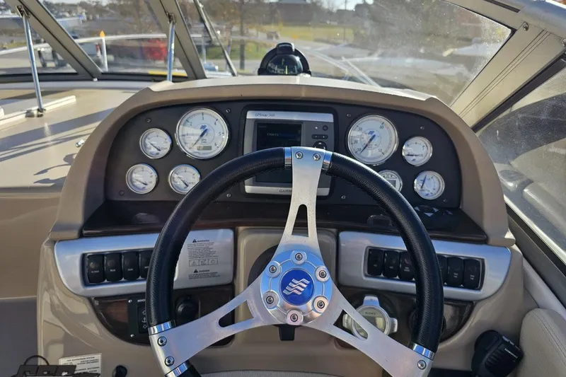 Slide: The Image of 2008 Four Winns V258 boat dashboard with steering wheel and gauges. - 44