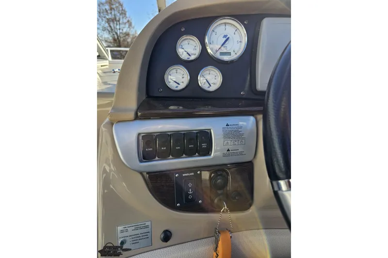 Slide: The Image of 2008 Four Winns V258 dashboard with gauges and control switches. - 45
