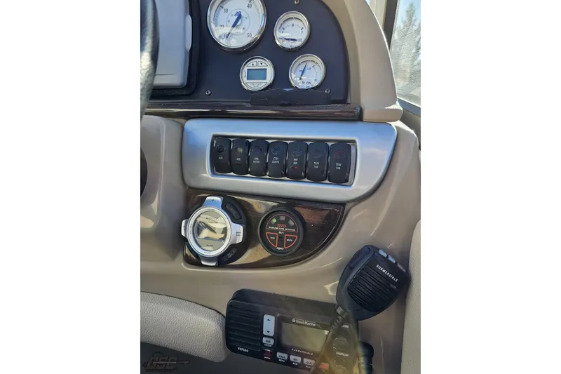 Slide: The Image of 2008 Four Winns V258 boat dashboard with gauges, controls, and communication equipment. - 46