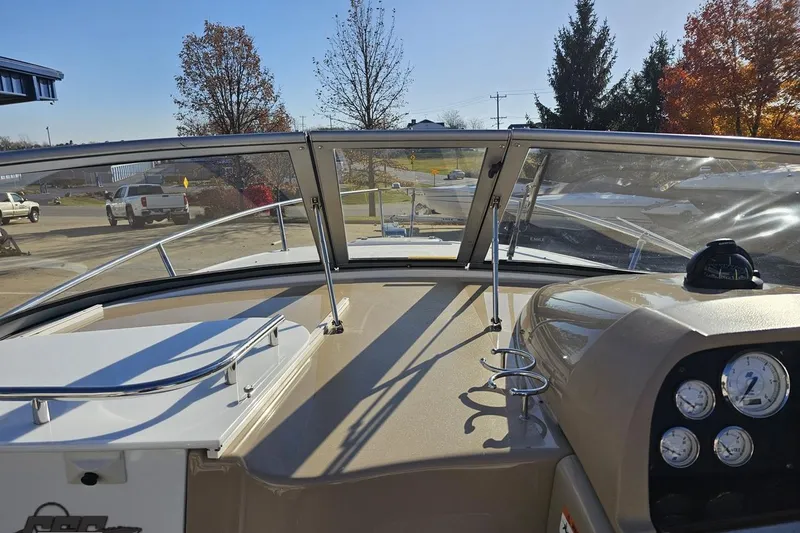 Slide: The Image of 2008 Four Winns V258 boat dashboard with gauges and windshield view. - 50