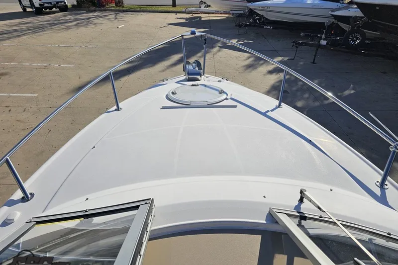 Slide: The Image of 2008 Four Winns V258 boat deck with open hatch, docked in a marina. - 51
