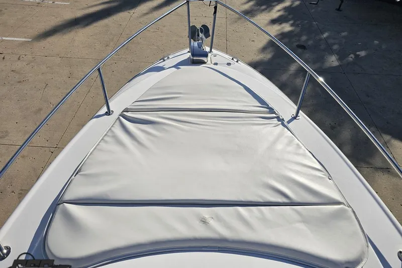 Slide: The Image of 2008 Four Winns V258 boat bow with white cushioned seating and stainless steel railings. - 53