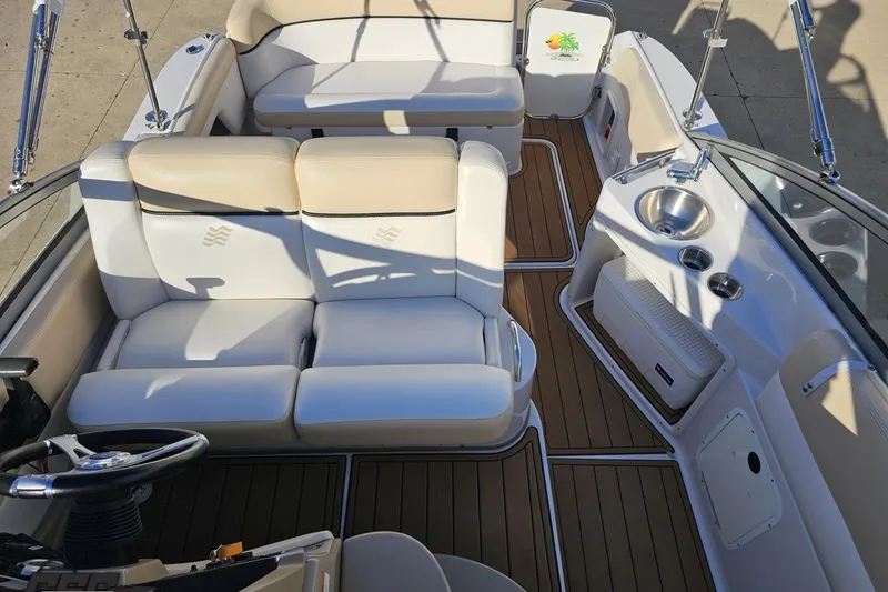 Slide: The Image of 2008 Four Winns V258 boat interior with beige seating and wood flooring. - 55