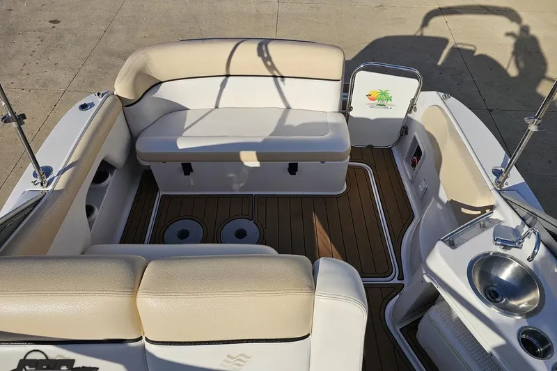 Slide: The Image of 2008 Four Winns V258 boat interior with beige seating and wood flooring. - 57