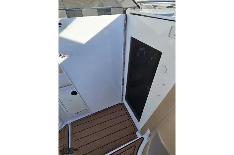 Slide: The Image of 2008 Four Winns V258 boat interior with wooden flooring and white panel door. - 58