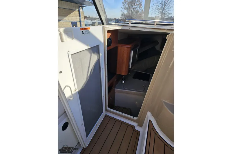 Slide: The Image of 2008 Four Winns V258 cabin entrance with wooden interior and open door. - 59