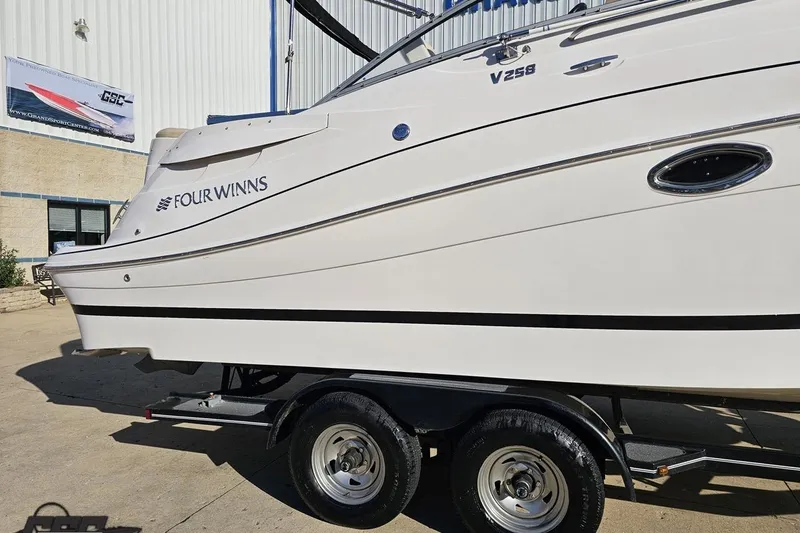 Slide: The Image of 2008 Four Winns V258 boat on trailer outside a building. - 6