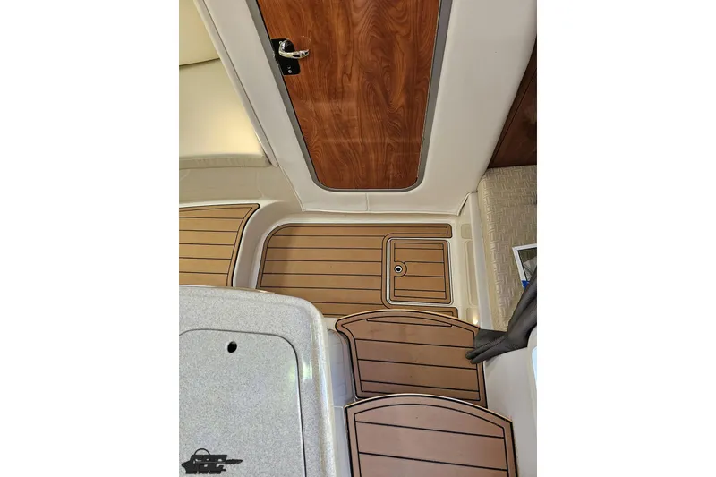 Slide: The Image of 2008 Four Winns V258 boat interior with wood and beige accents. - 63