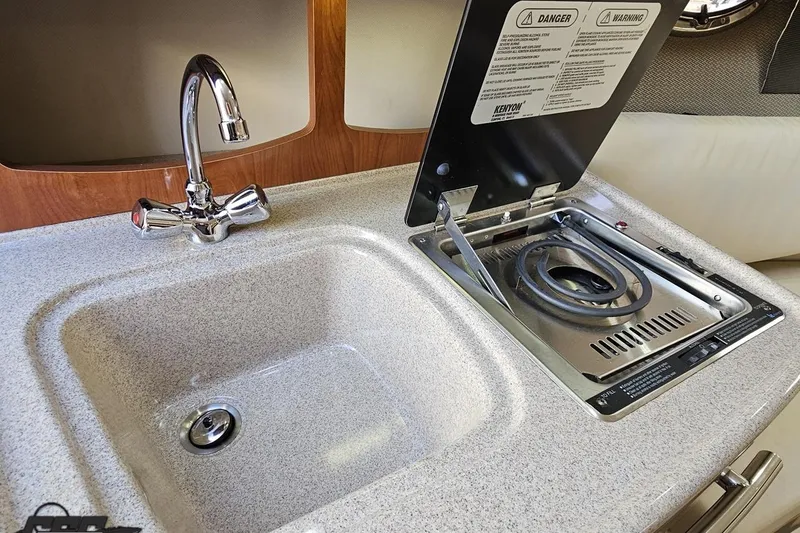 Slide: The Image of 2008 Four Winns V258 boat kitchen with sink and stove. - 66