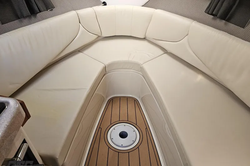 Slide: The Image of 2008 Four Winns V258 boat interior with beige seating and wood flooring. - 67