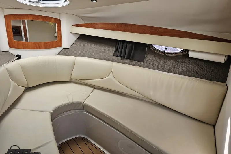 Slide: The Image of 2008 Four Winns V258 boat interior with beige seating and wood accents. - 68