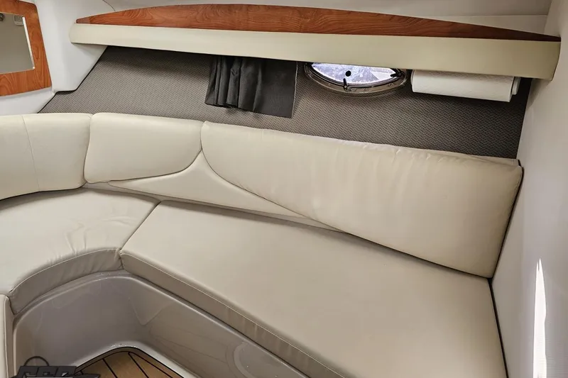 Slide: The Image of 2008 Four Winns V258 cabin interior with beige seating and wood accents. - 69