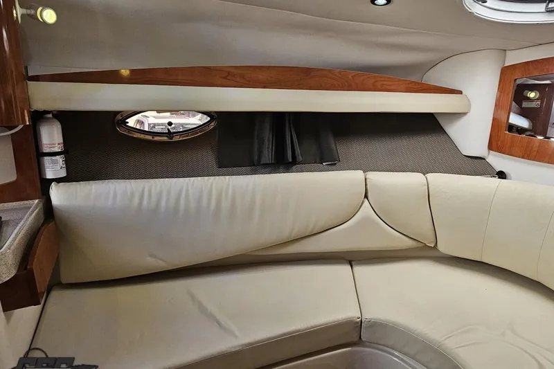 Slide: The Image of 2008 Four Winns V258 cabin interior with beige seating and wood accents. - 70