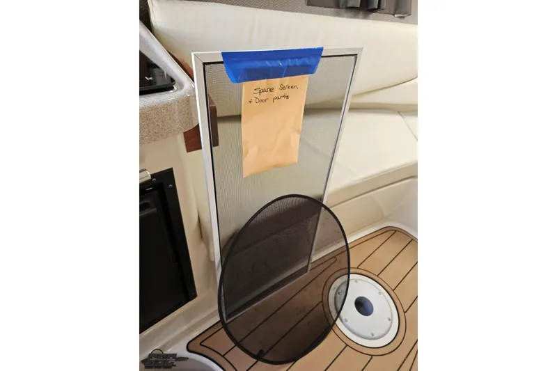 Slide: The Image of 2008 Four Winns V258 boat interior with spare screen and door parts. - 72