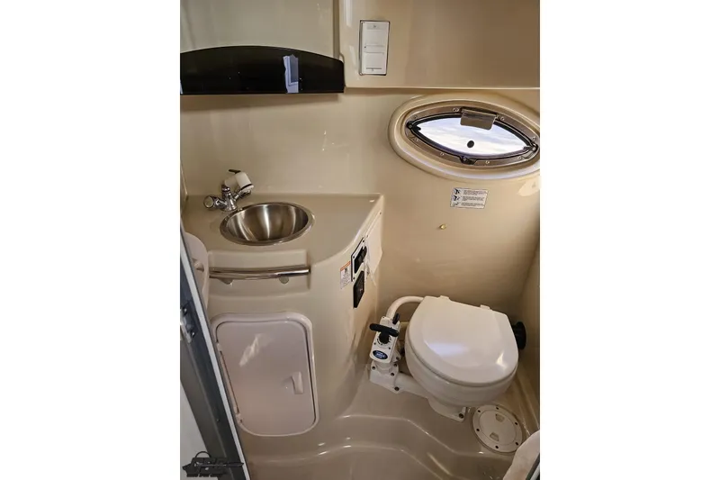 Slide: The Image of Compact bathroom in 2008 Four Winns V258 boat with sink and toilet. - 75