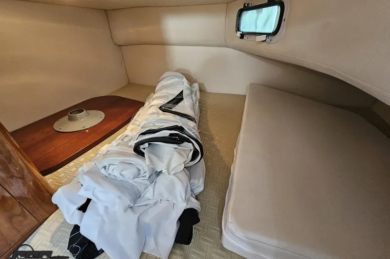 Slide: The Image of 2008 Four Winns V258 cabin interior with rolled-up bedding and window. - 79