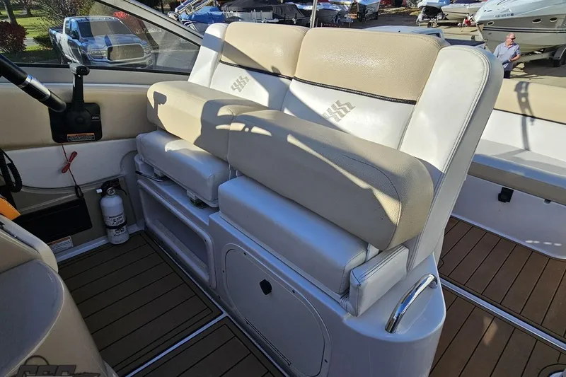 Slide: The Image of 2008 Four Winns V258 boat interior with beige seating and wooden flooring. - 84
