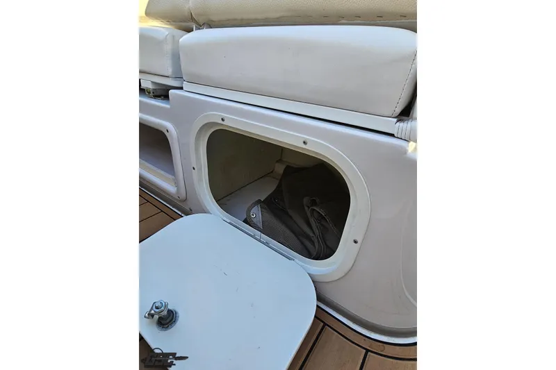 Slide: The Image of 2008 Four Winns V258 boat storage compartment with open hatch and visible interior. - 85