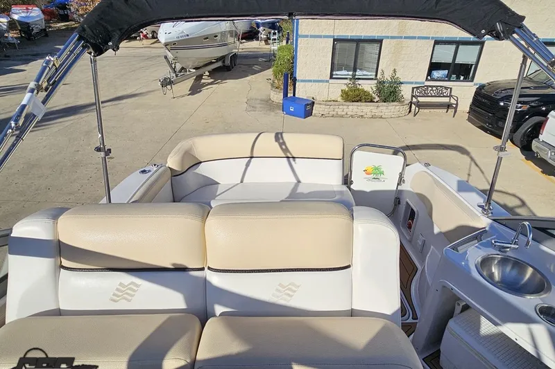 Slide: The Image of 2008 Four Winns V258 boat interior with seating and sink, docked outdoors. - 86