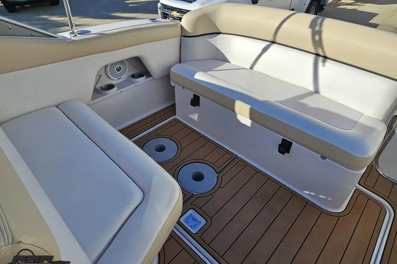 Slide: The Image of 2008 Four Winns V258 boat interior with cushioned seating and wood-style flooring. - 89