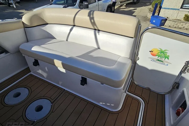 Slide: The Image of 2008 Four Winns V258 boat interior with cushioned seating and tropical-themed door design. - 90