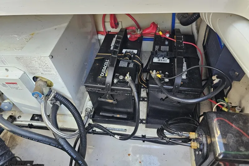 Slide: The Image of Battery compartment of 2008 Four Winns V258 boat with Duracell batteries and wiring. - 94