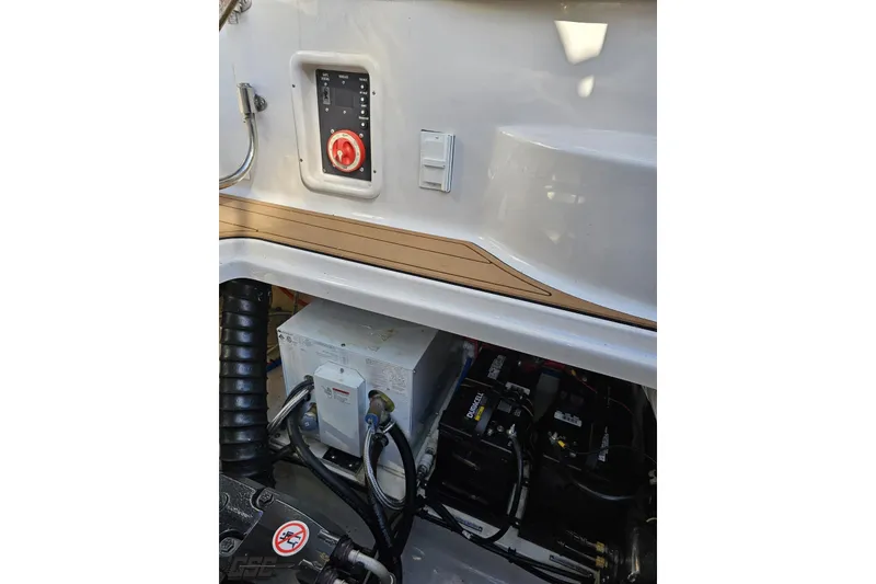 Slide: The Image of 2008 Four Winns V258 boat electrical panel and battery compartment. - 95