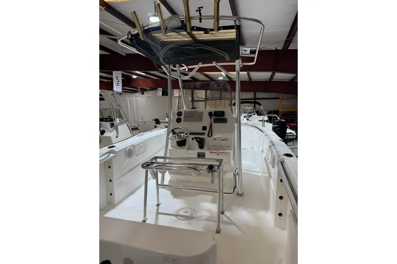 Slide: The Image of 2007 Wellcraft 232 Fisherman boat interior with steering console and T-top in a showroom. - 9