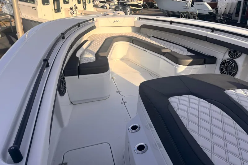 Slide: The Image of 2026 Yellowfin 36 Offshore boat interior with cushioned seating and sleek design. - 10