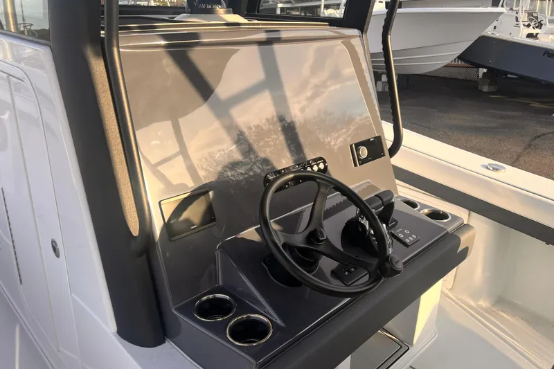 Slide: The Image of 2026 Yellowfin 36 Offshore boat helm with steering wheel and controls. - 12