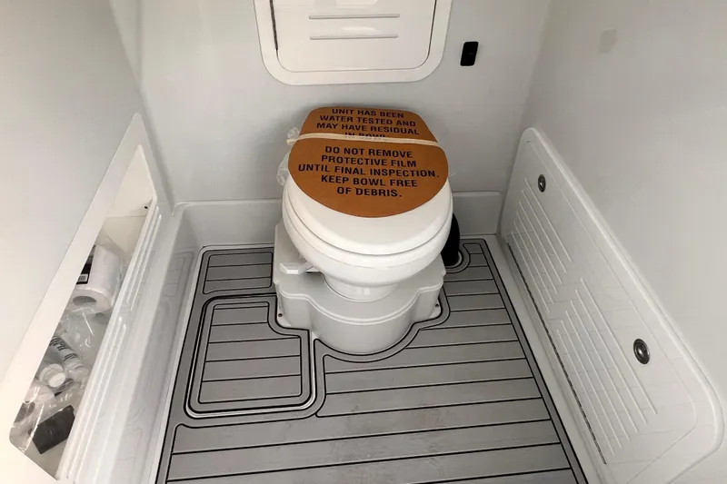 Slide: The Image of 2026 Yellowfin 36 Offshore boat bathroom with protective film on toilet. - 17