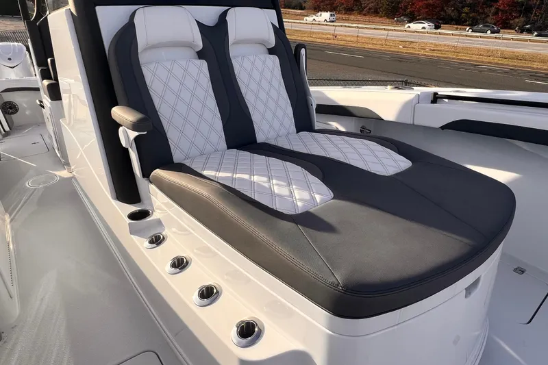 Slide: The Image of 2026 Yellowfin 36 Offshore boat seating with luxurious white and black upholstery. - 6