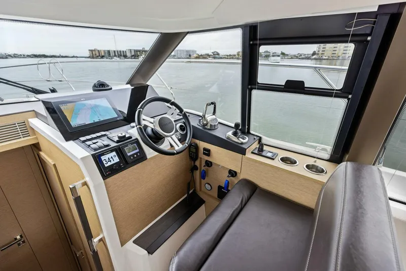 Slide: The Image of Interior of 2022 Prestige 420 yacht cockpit with navigation controls and panoramic windows. - 13