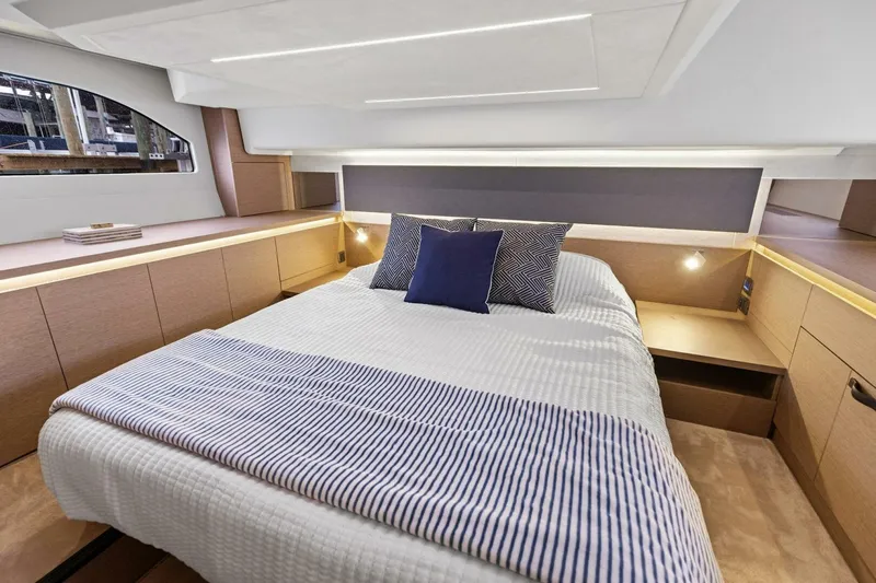 Slide: The Image of Luxurious cabin interior of 2022 Prestige 420 yacht with modern bedding and ambient lighting. - 15