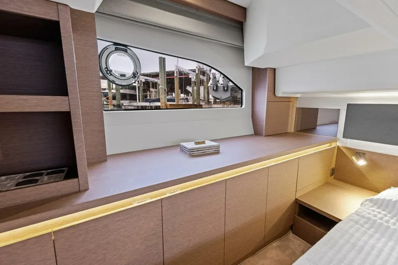 Slide: The Image of Luxurious interior of 2022 Prestige 420 yacht with modern wood finish and window view. - 19