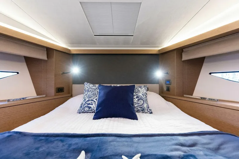 Slide: The Image of Luxurious bedroom interior of 2022 Prestige 420 yacht with elegant bedding and ambient lighting. - 25
