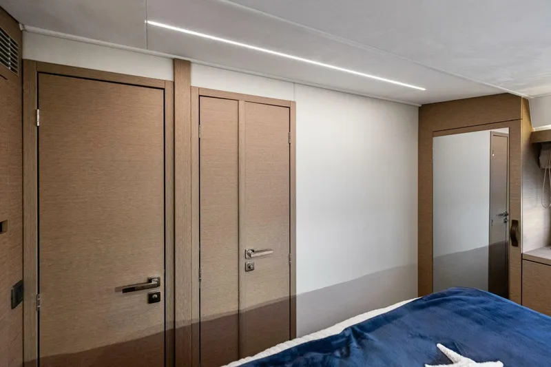 Slide: The Image of Modern interior of 2022 Prestige 420 yacht cabin with wooden doors and mirror. - 26