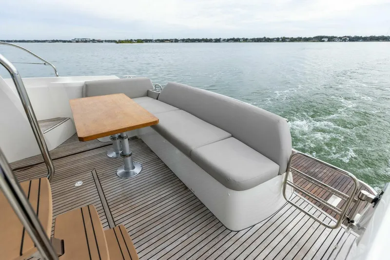 Slide: The Image of Luxury seating area on 2022 Prestige 420 yacht with scenic water view. - 33