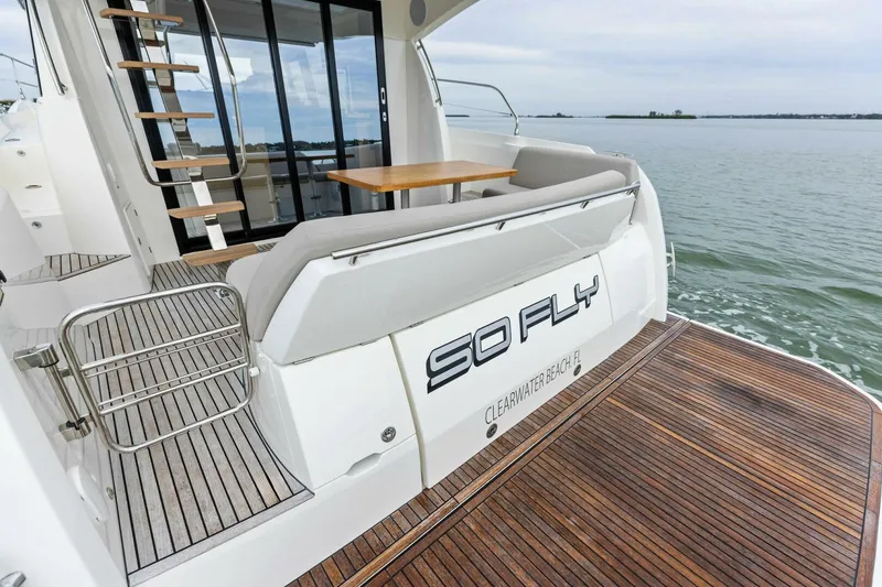 Slide: The Image of Luxury 2022 Prestige 420 yacht with wooden deck, docked at sea. - 34