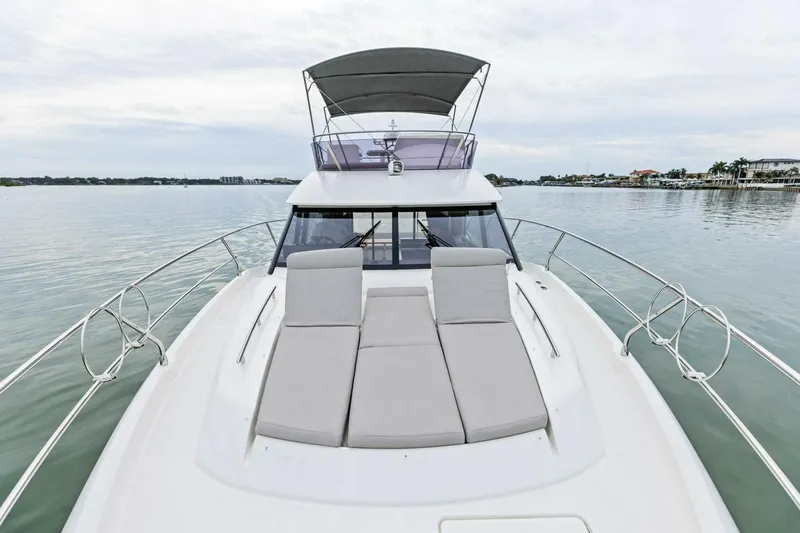 Slide: The Image of 2022 Prestige 420 yacht with sun loungers on calm water. - 4