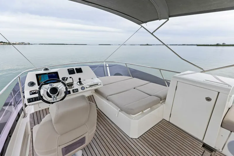 Slide: The Image of Luxurious 2022 Prestige 420 yacht helm with modern controls and spacious seating. - 42